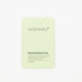 Noshinku Pear Blossom Tea hydrating hand sanitizer in a pale yellow-green rectangular bottle shown on a clean white background.