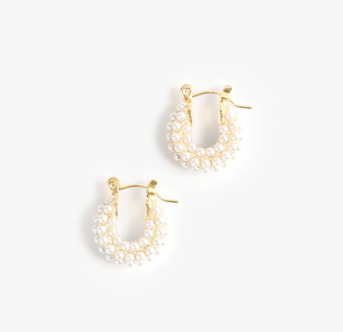 Gold hoop earrings with pearl accents on a white background