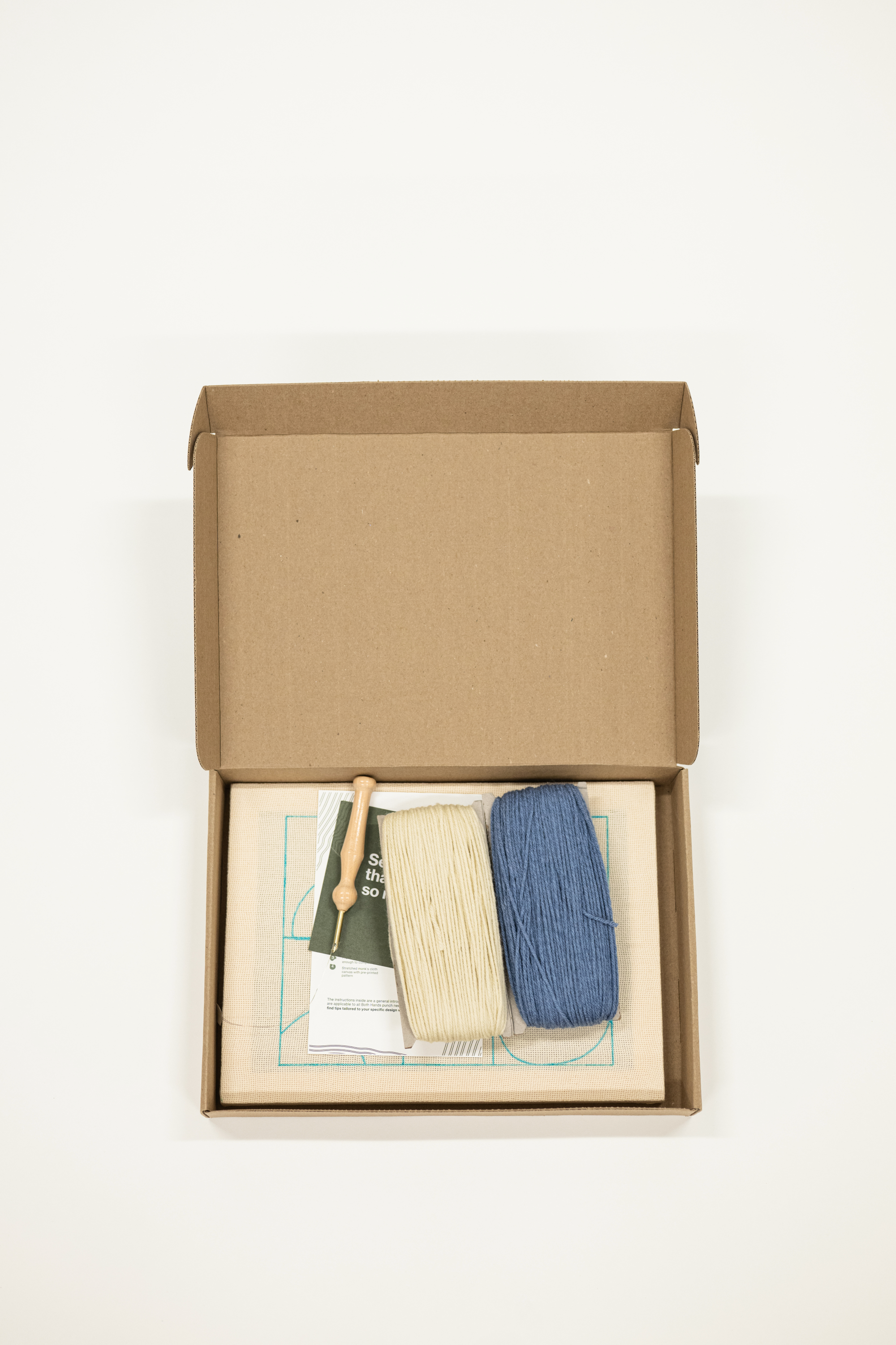 Punch needle kit with two colored threads and canvas