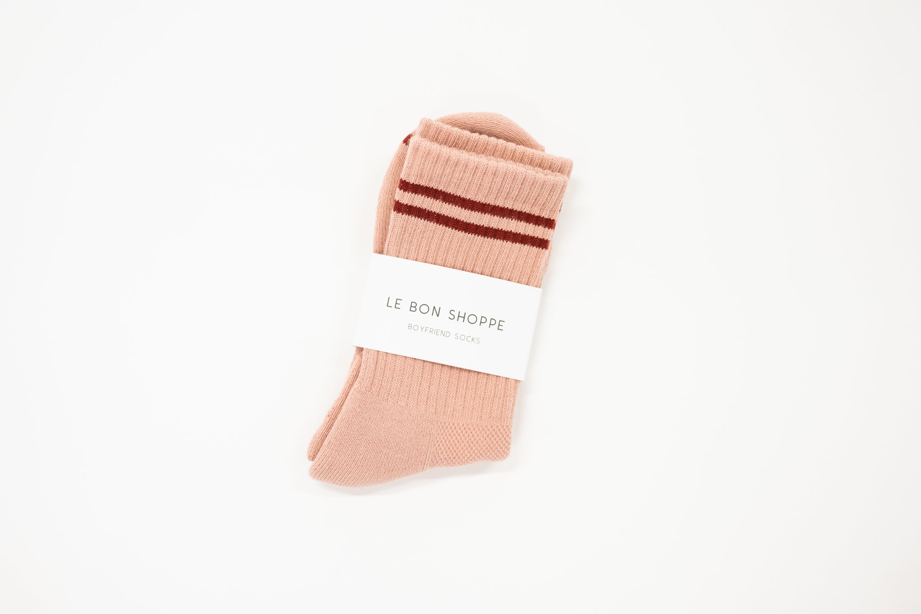 light pink boyfriend style crew sock with deep red stripe and white label saying le bon shoppe