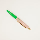 Pen with green cap and pink body on a white background
