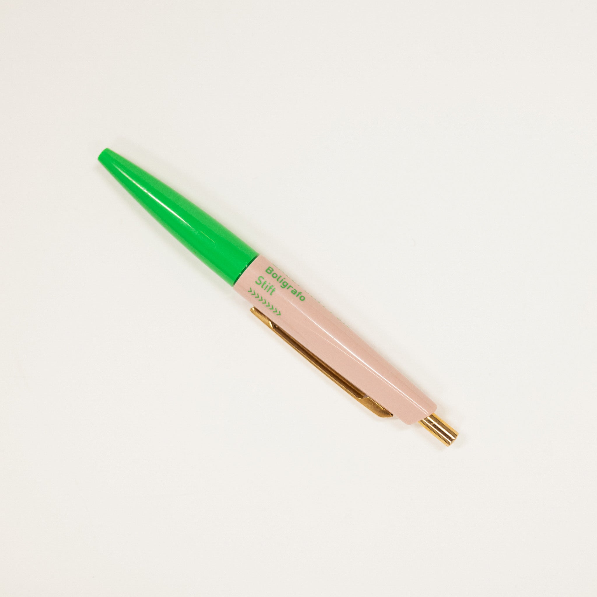 Pen with green cap and pink body on a white background