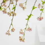 Floral branches with small pink flowers on a light background