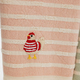 detail of embroidered chicken wearing a red and white striped sweater. on a turkish cotton striped towel