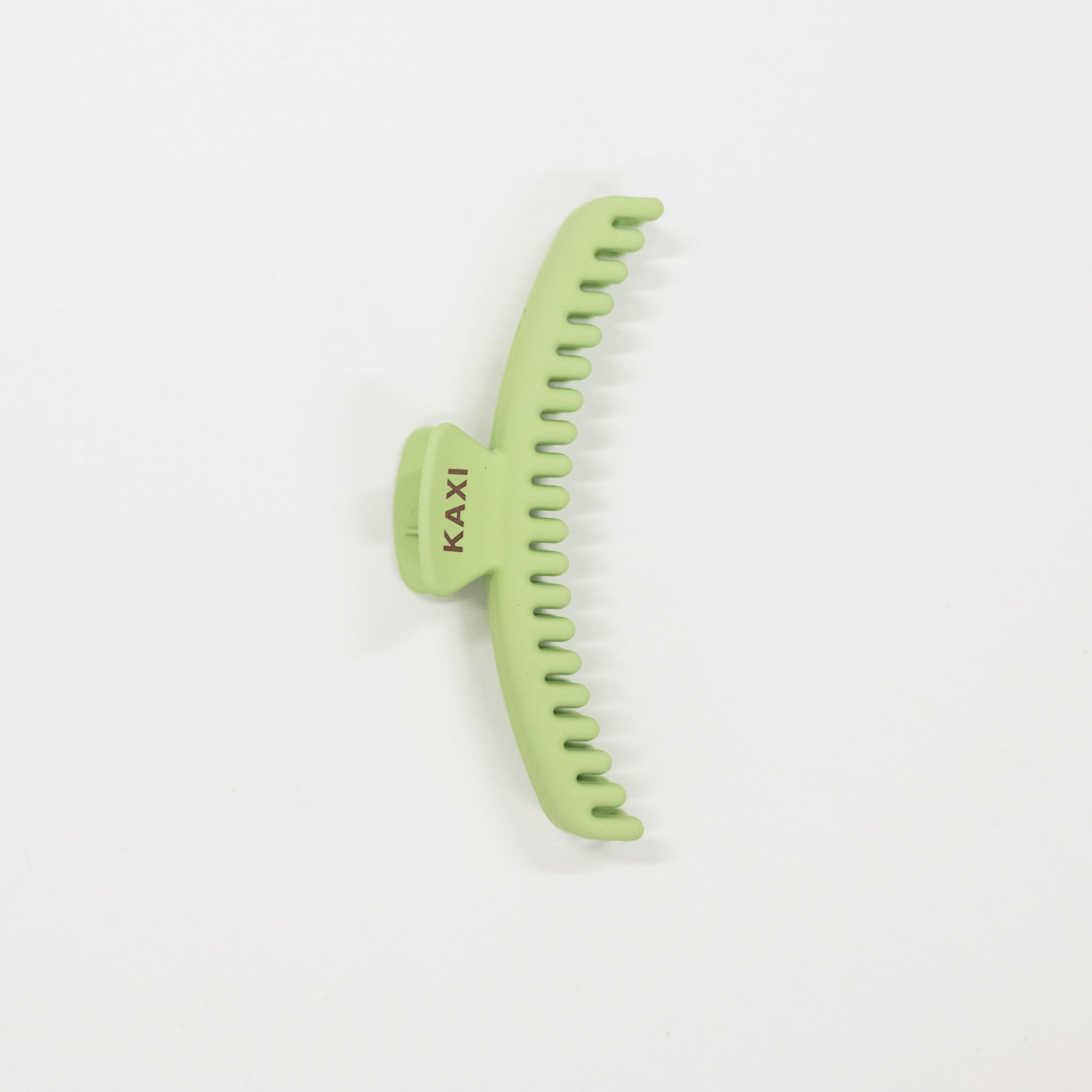 Green hair claw with 'KAXI' branding on a white background