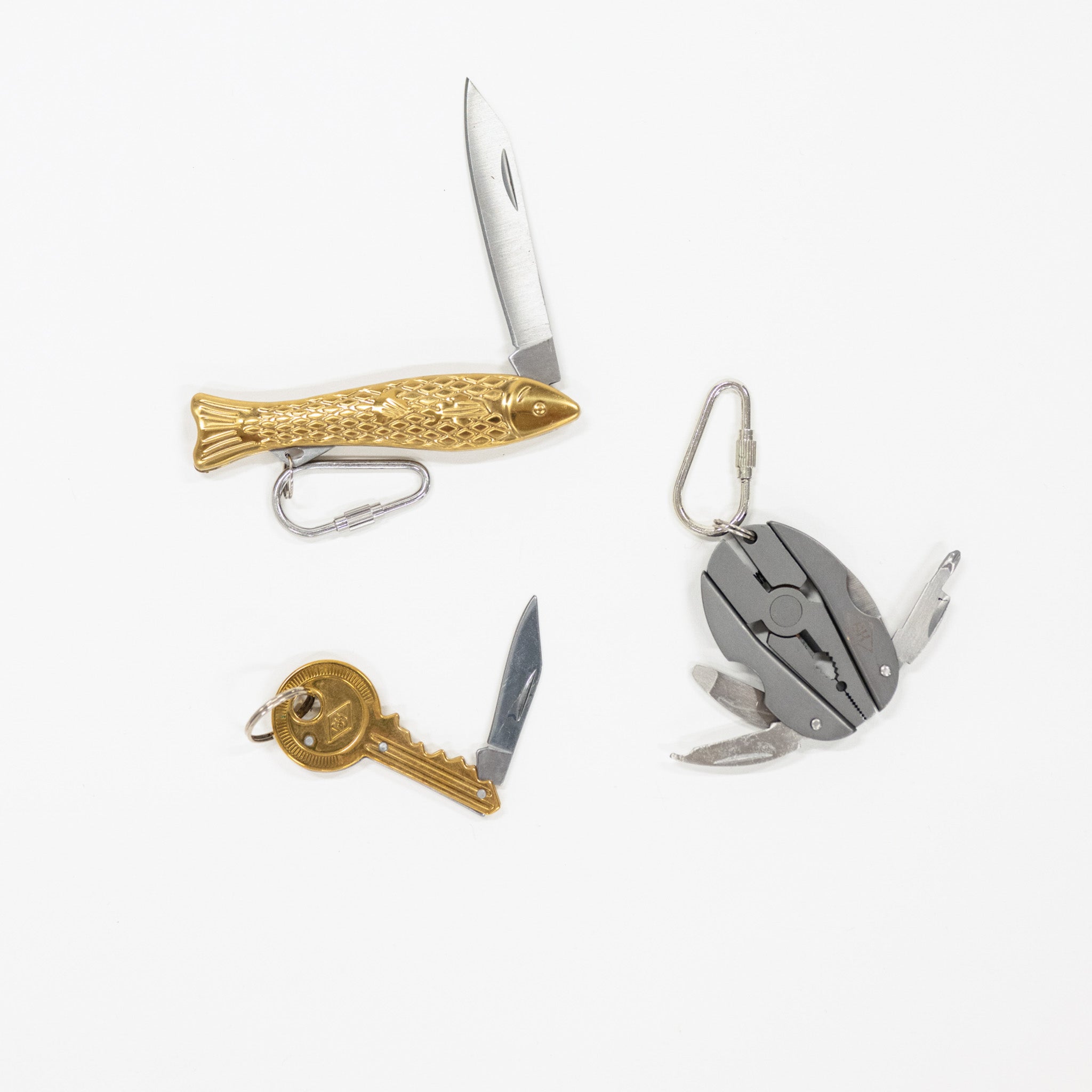 Collection of multi-tool keychains on a white background