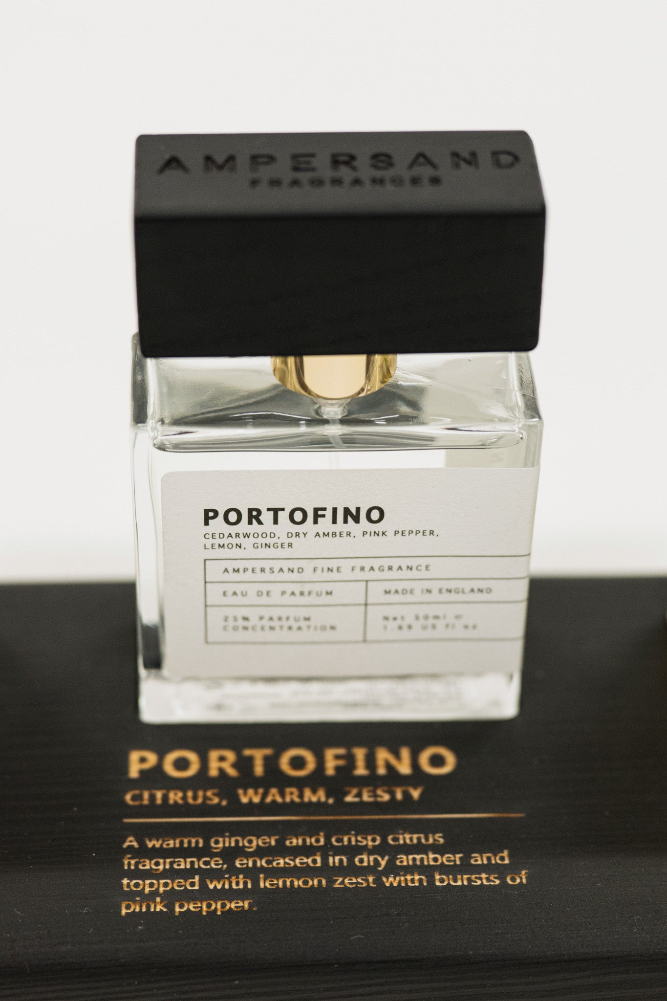 Perfume bottle labeled 'Portofino' by Ampersand Fragrances on a black background