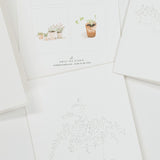 A set of white art print cards featuring minimalist black line drawings of potted plants and one central card with a small watercolor illustration of potted plants and the text 'EMILY LEX STUDIO'.