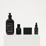 Set of grooming products including hand wash, beard oil, and other items on a white background