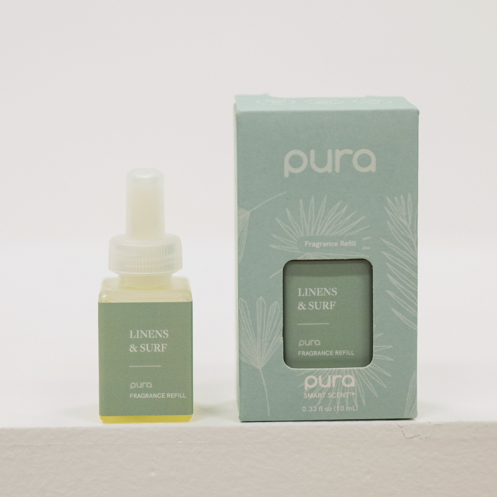 Pura Linens & Surf fragrance refill bottle and packaging on a light gray background