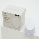 Pura smart fragrance diffuser with packaging on a white background