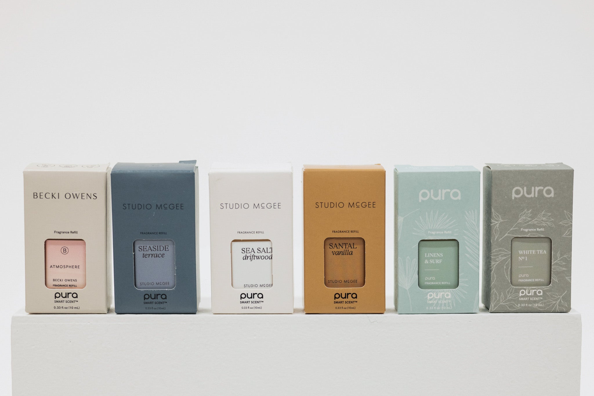 Row of pura boxes with different brands on a white background