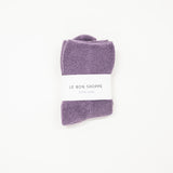 purple cloud socks on a white surface, each with a label indicating the brand le bon shoppe