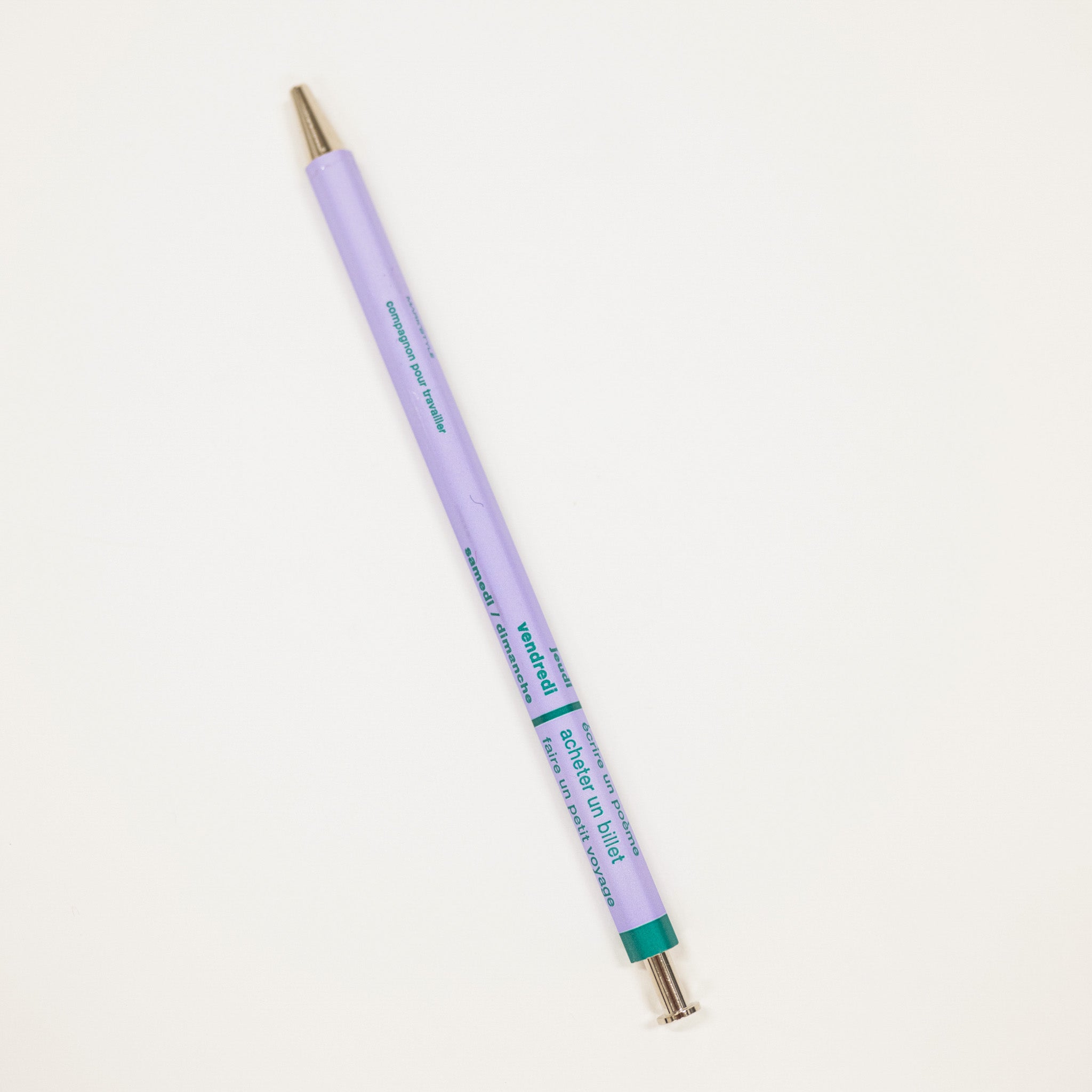 Purple pen with gold cap on a light gray background