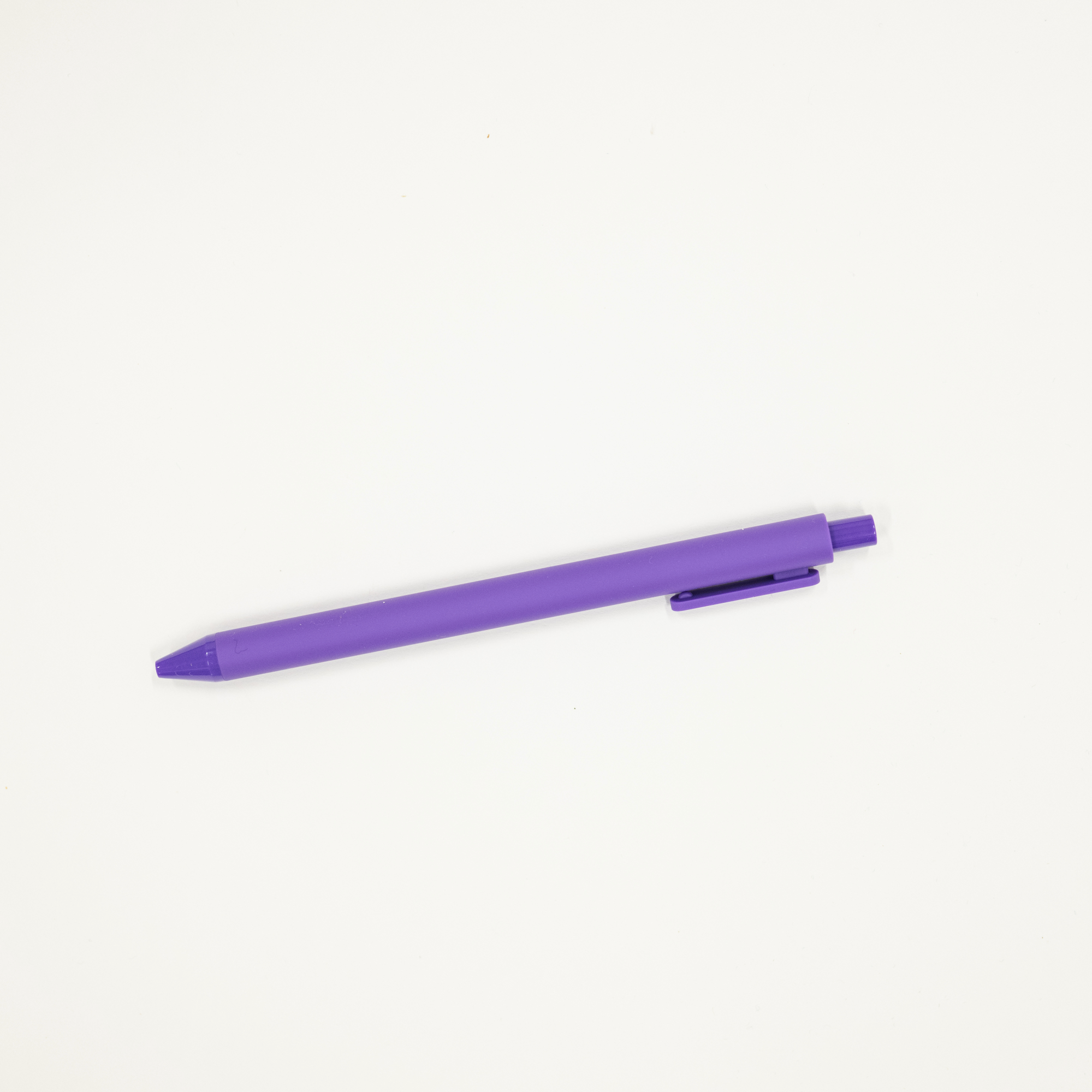 Purple pen on a white background