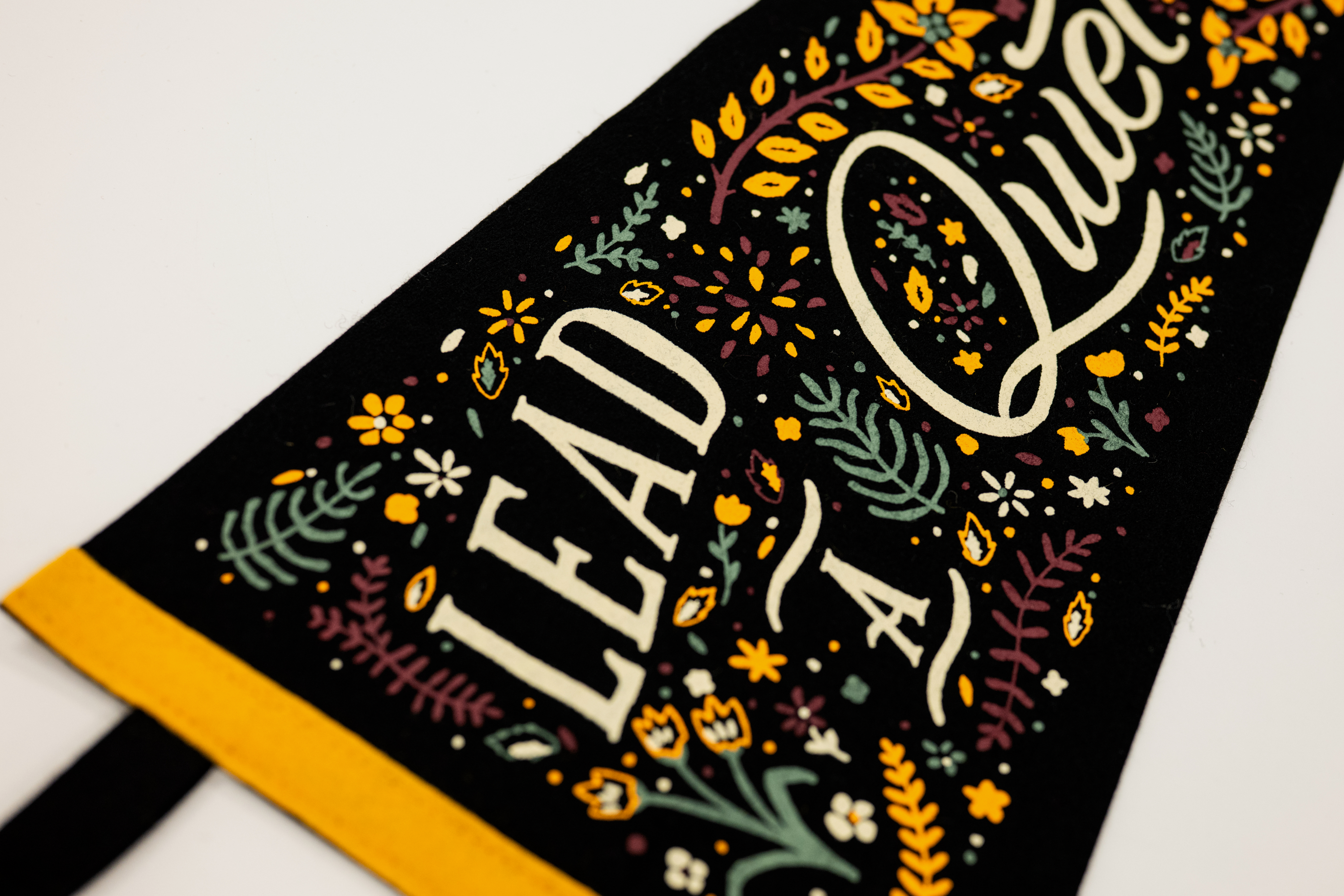 Decorative towel with floral patterns and text on a white background