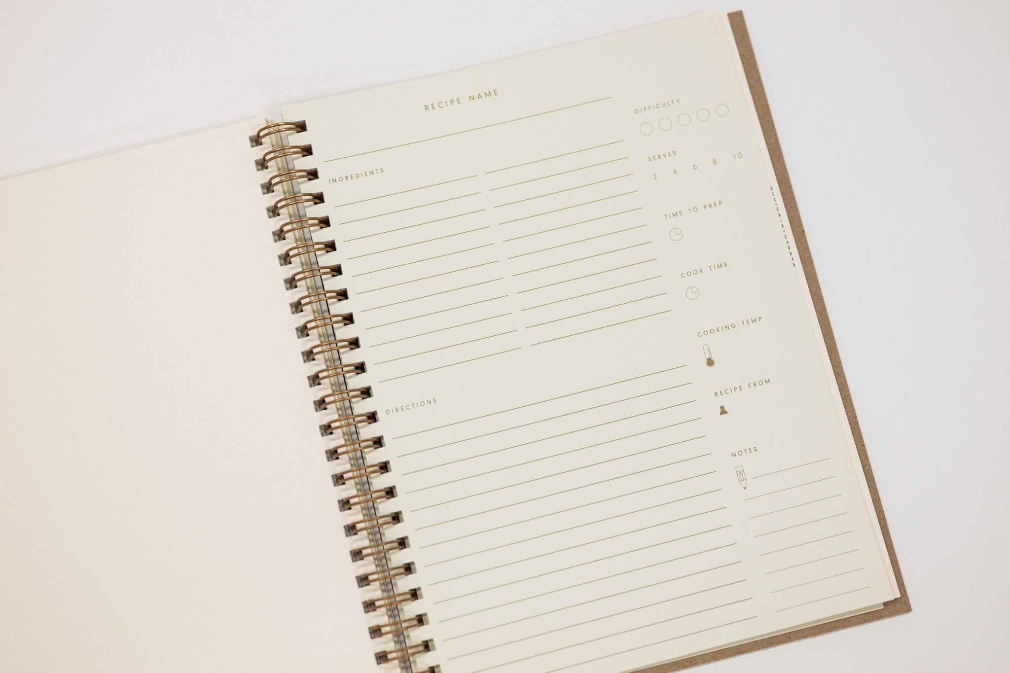 Open spiral-bound recipe notebook with lined pages on a white background