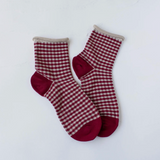 red and oatmeal colored checks with a rolled top, pair of socks