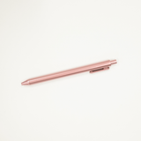 Rose gold pen on a white background