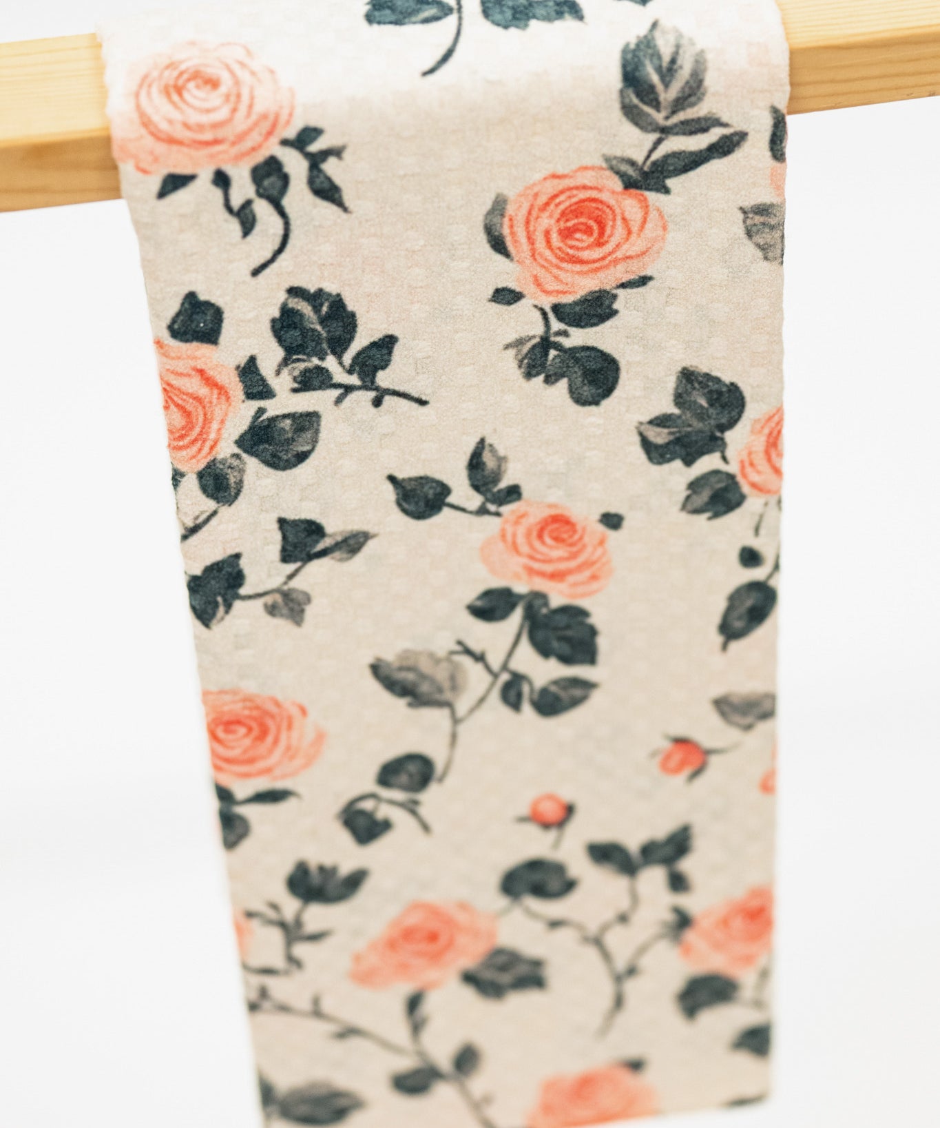 Floral patterned fabric hanging on a wooden rod