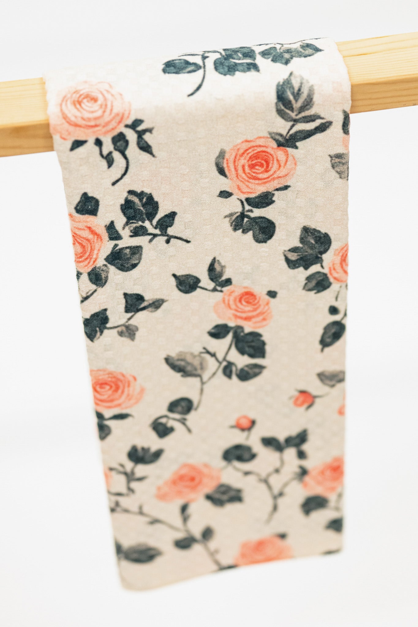 Floral patterned fabric hanging on a wooden rod