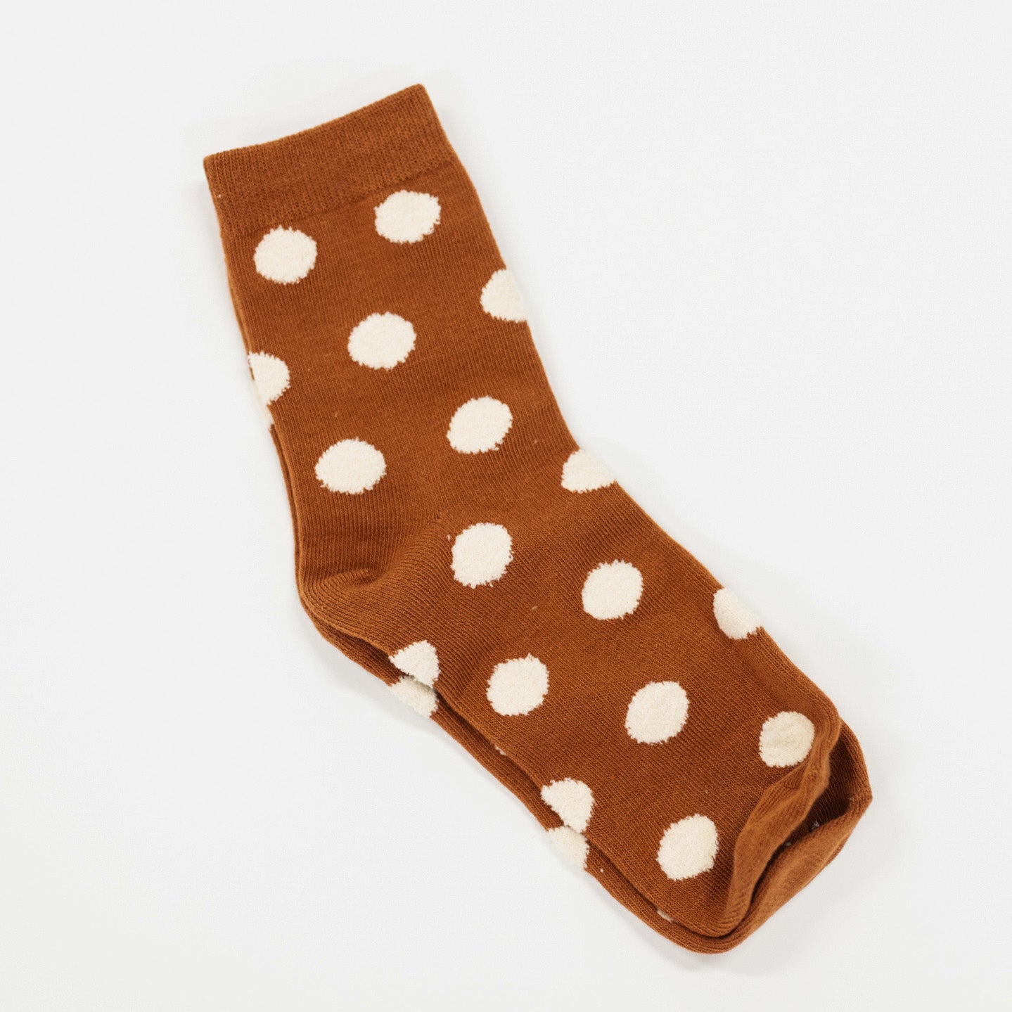 rust colored socks with puff raised white dots