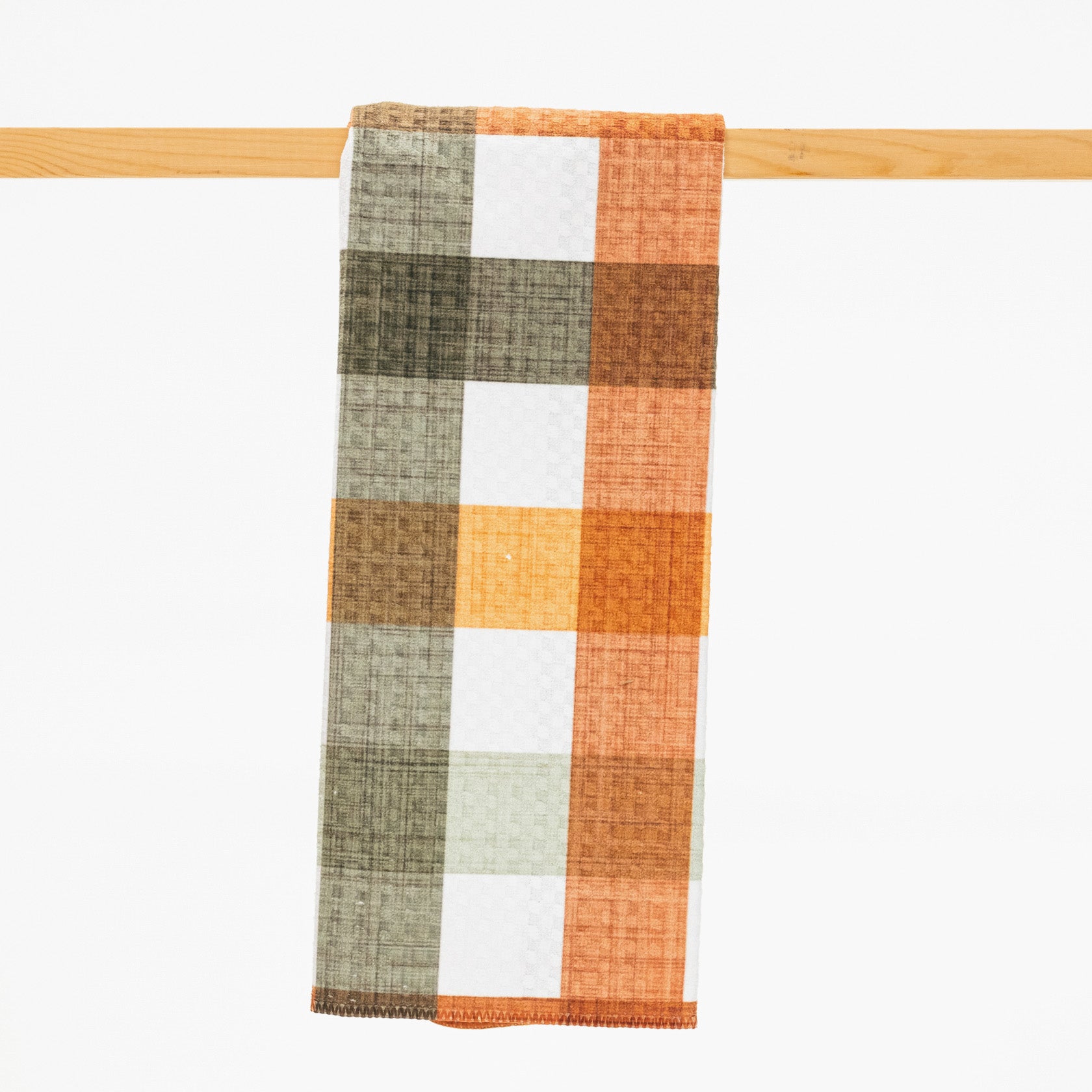 plaid pattern kitchen towel in fall colors of rust sage and mustard.