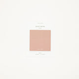 Minimalist design with a pink square color swatch on a light beige background