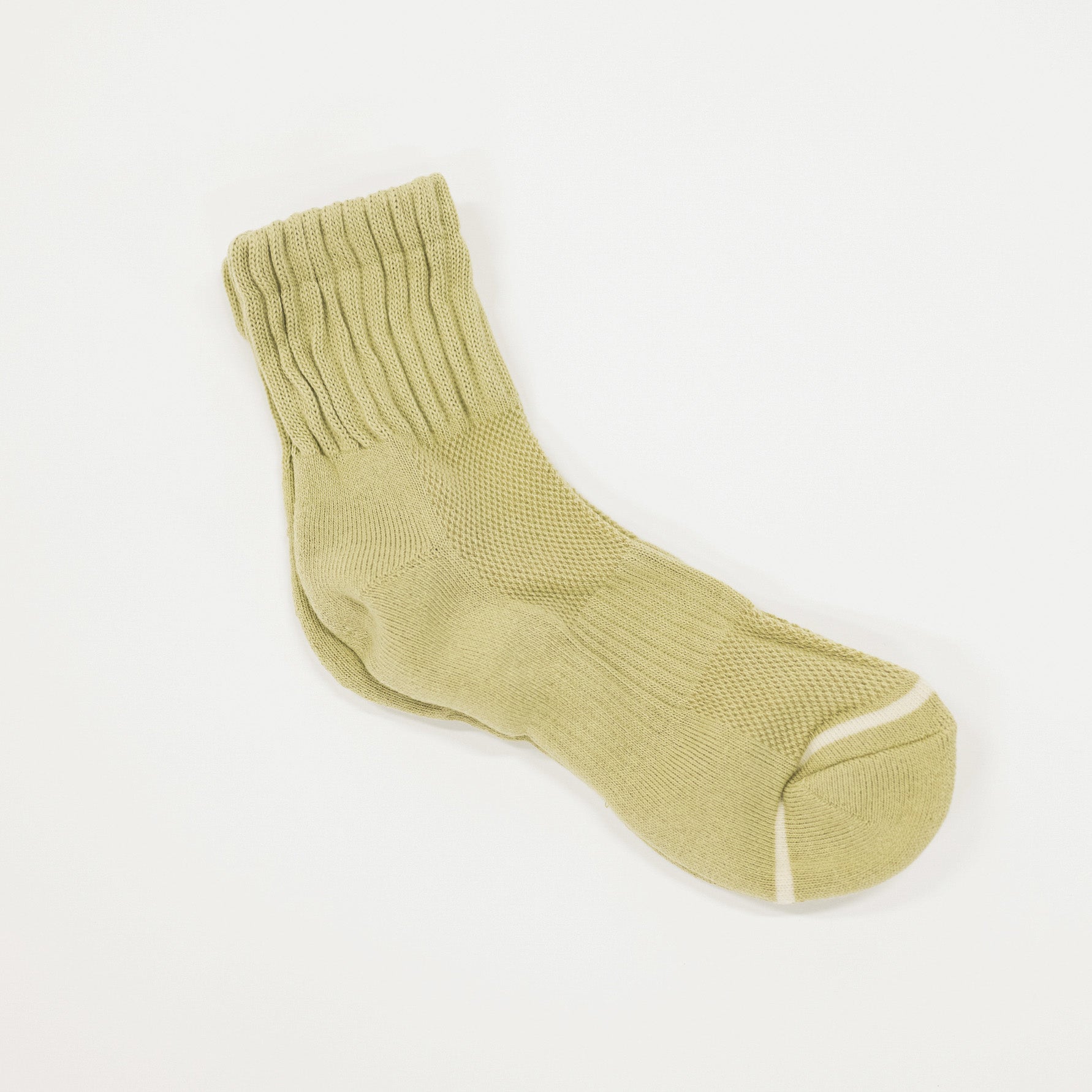 A single light olive green ribbed knit sock with a contrasting white toe stripe, displayed on a clean white background.