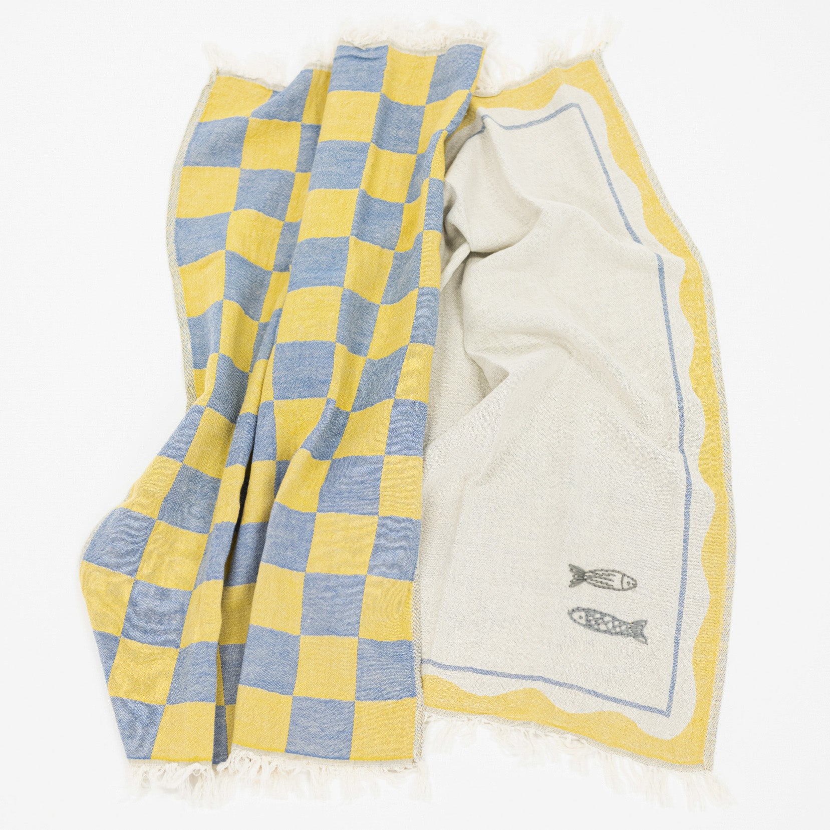 A woven kitchen towel with a yellow and blue checkered pattern on one side and a cream-colored center with a yellow border and small fish embroidery, displayed on a white background.