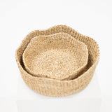 Two nested round woven baskets made of natural jute or seagrass, shown on a clean white background.