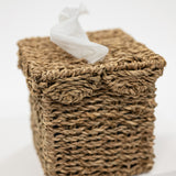 Woven basket with a white decorative figure on a light background
