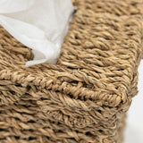 Woven basket with a white tissue inside on a light background