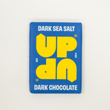 Blue and yellow chocolate bar packaging with 'UP' branding on a light gray background