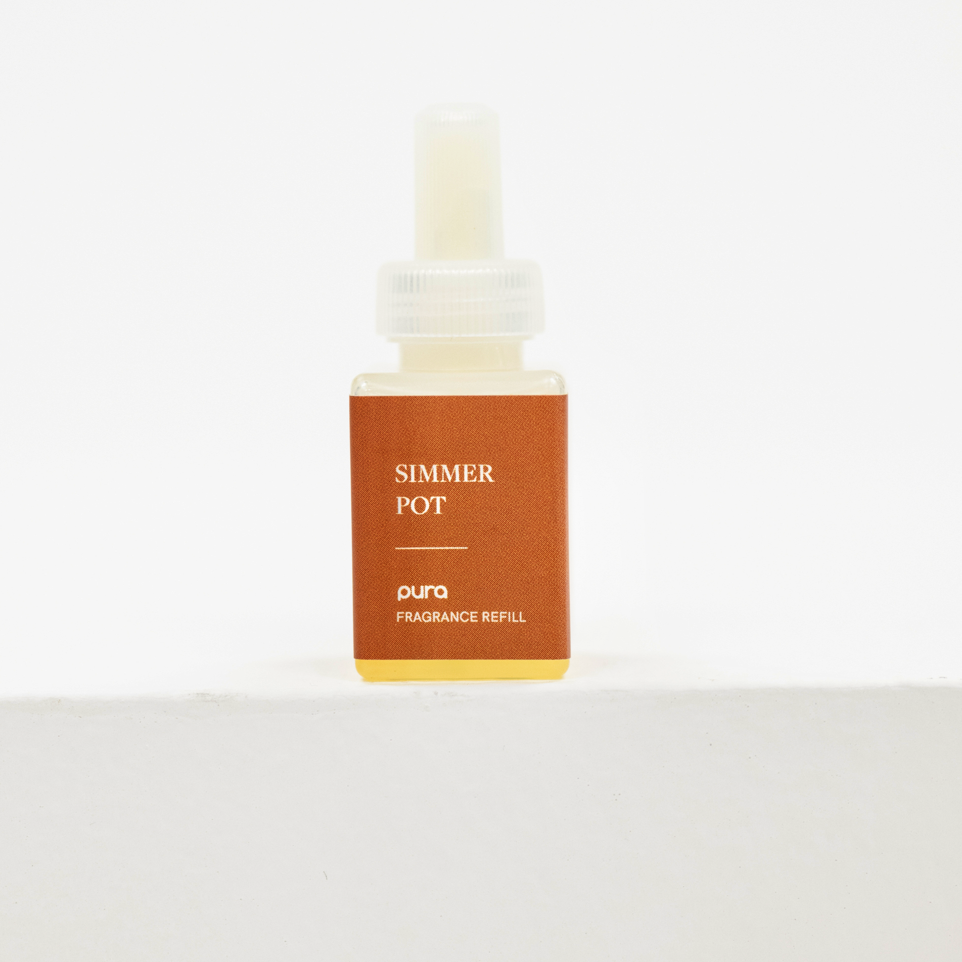 A small rectangular fragrance refill bottle labeled 'SIMMER POT' and 'puro FRAGRANCE REFILL' on a plain white background. Fall scent for pura.