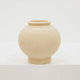 Cream ceramic vase on a light gray background