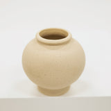 Cream ceramic vase on a white background