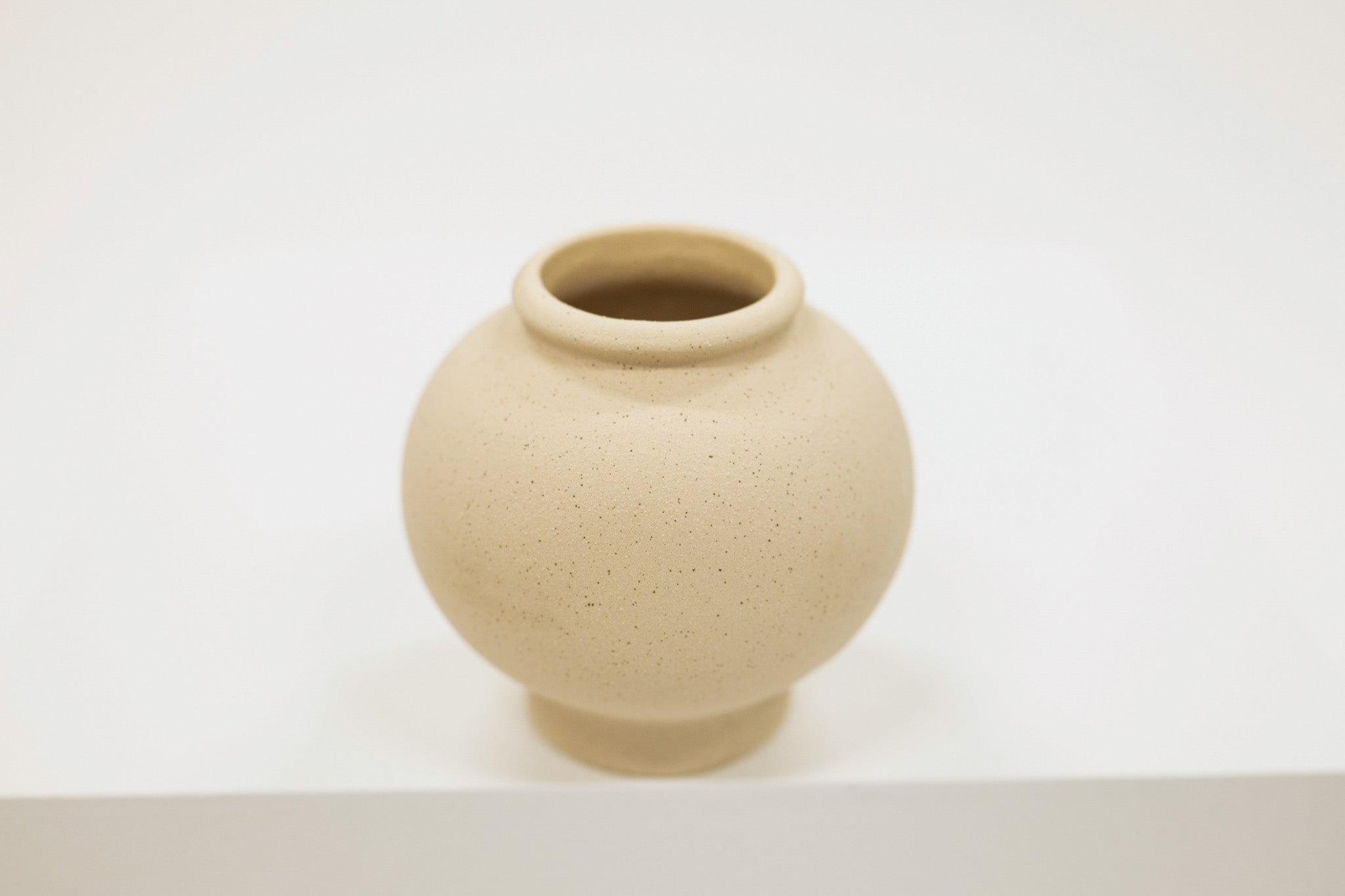 Cream ceramic vase on a white background