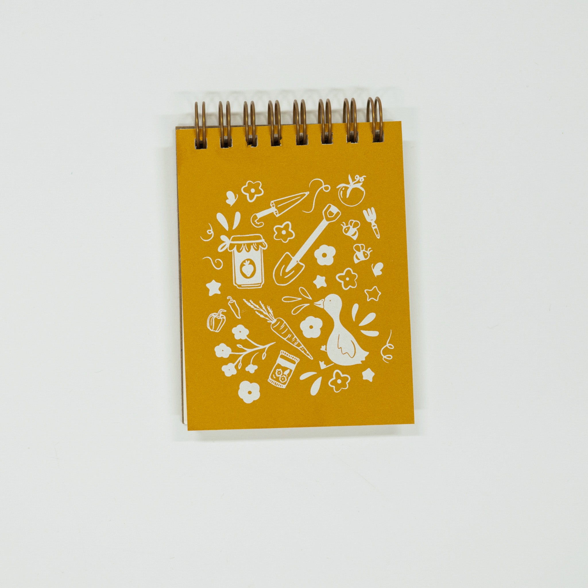 Yellow notebook with white illustrations on a light gray background