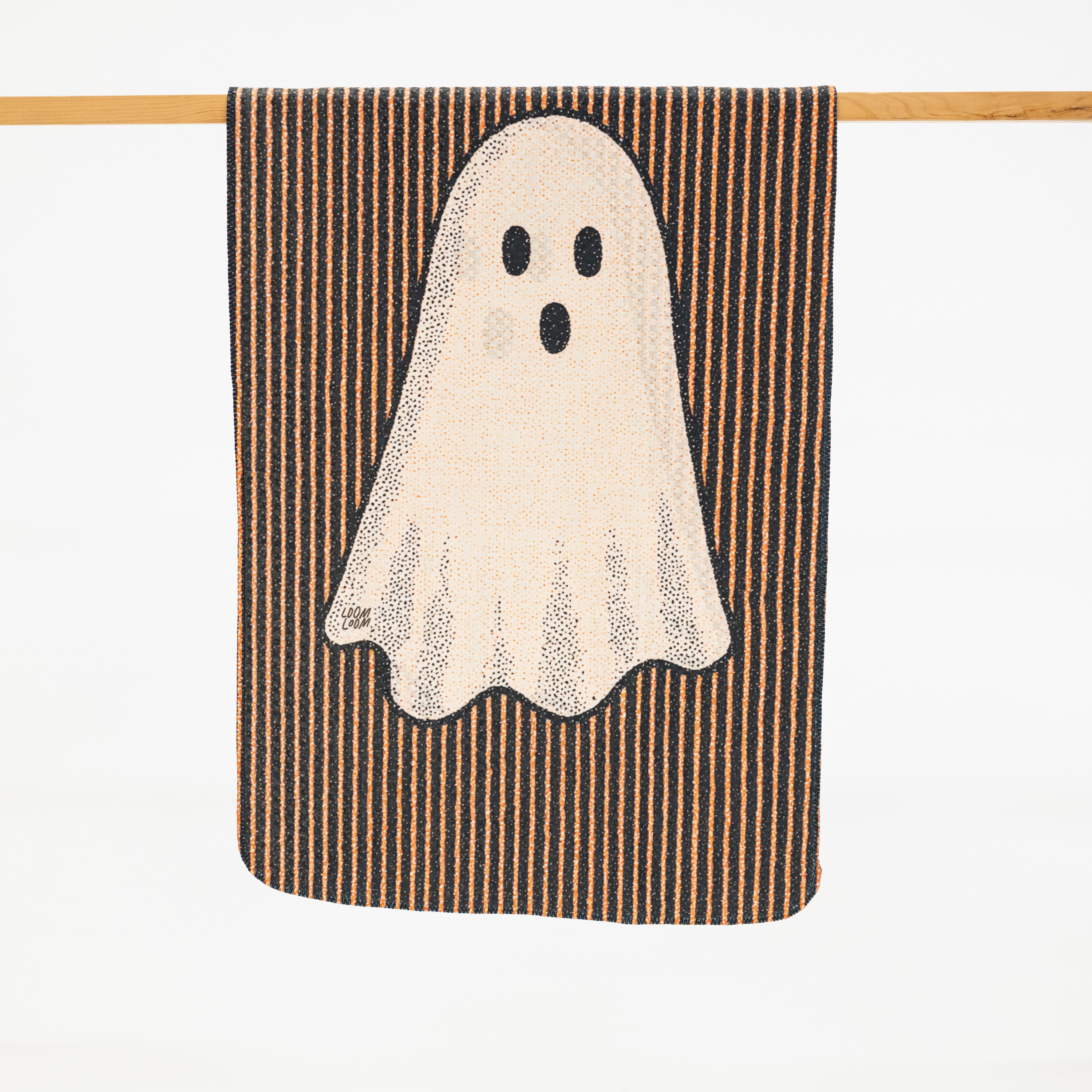 a microfiber kitchen towel with black and orange striped background a friendly ghost.