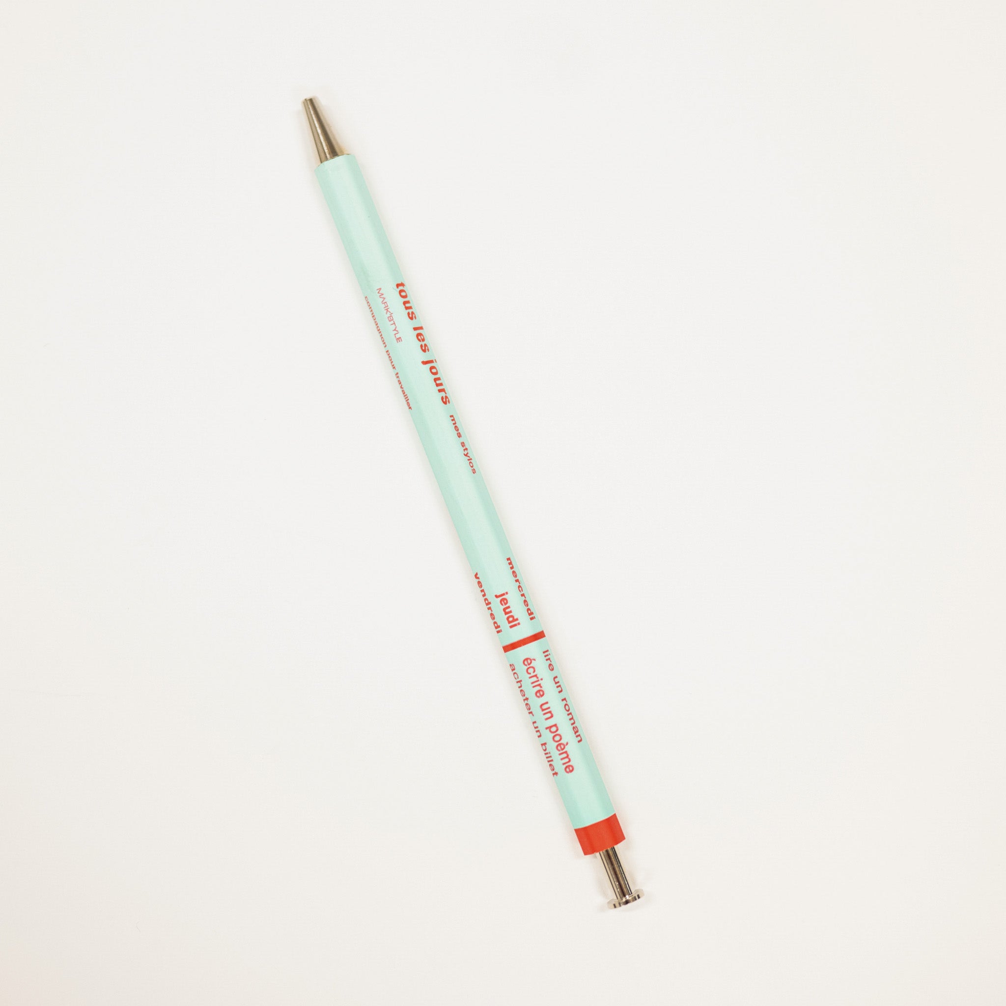 Mint green pen with red accents on a white background