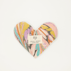Heart-shaped product with a colorful design and 'LOVE MERT' label on a white background