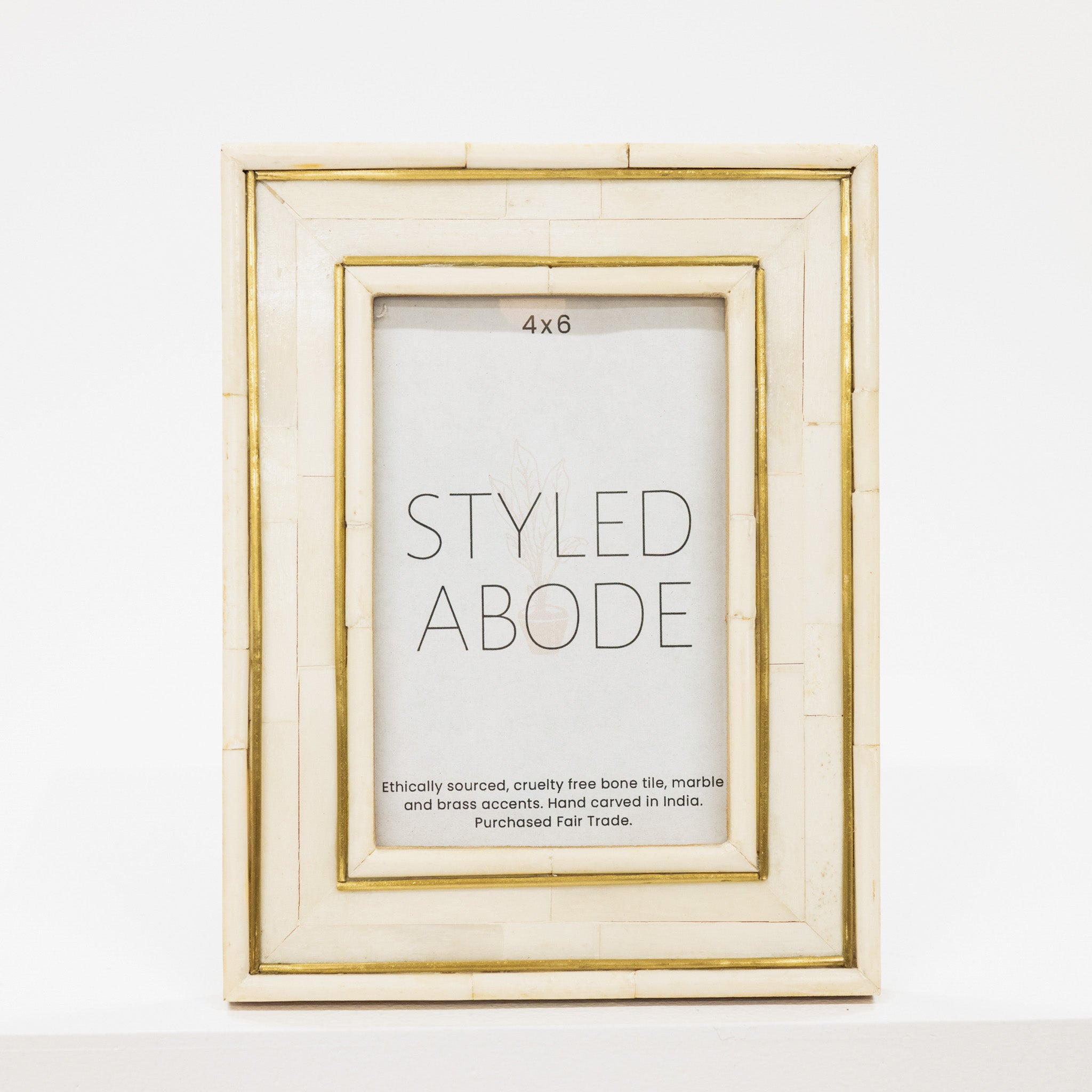 cream picture frame with gold accents on a white background