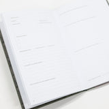 Open notebook with lined pages on a white background