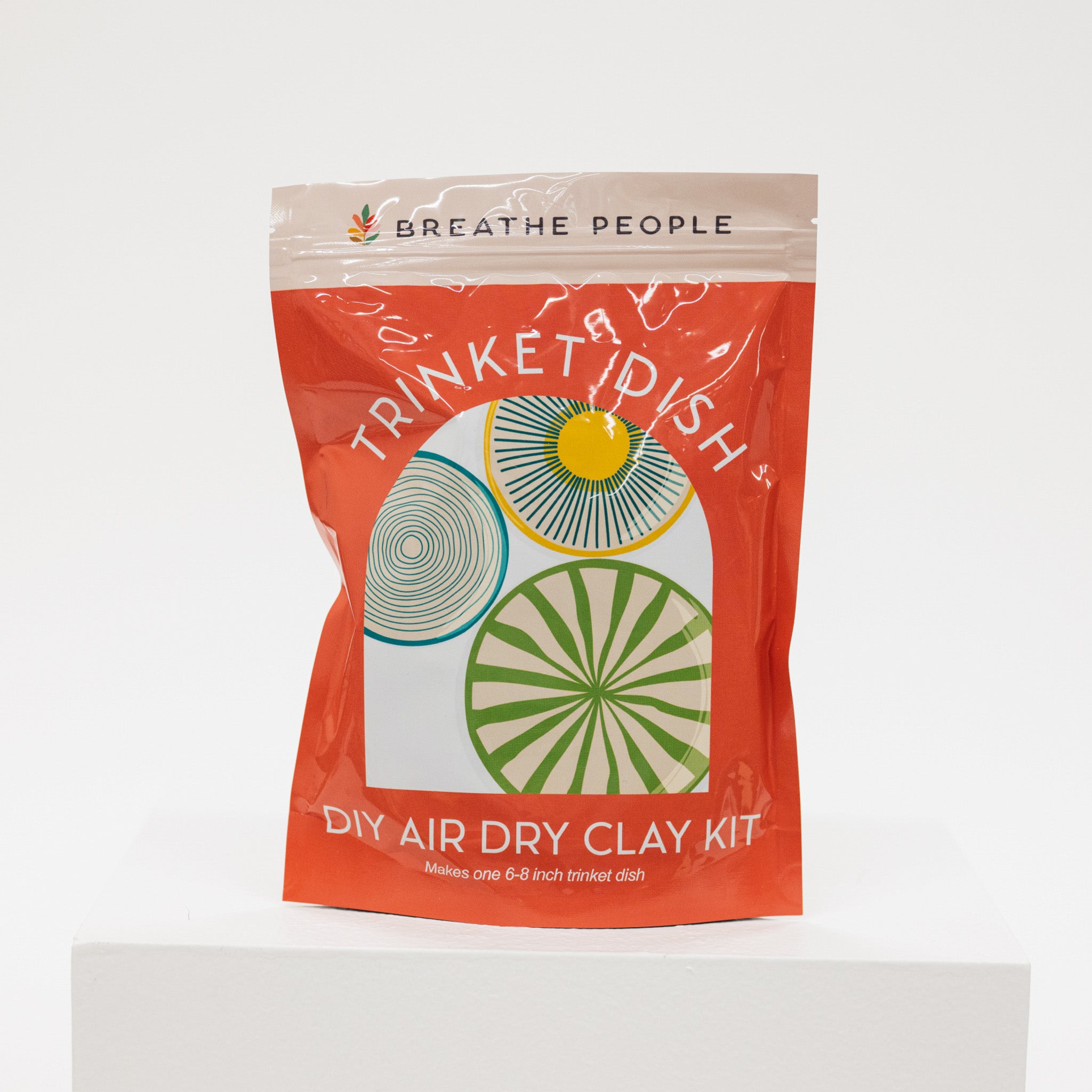 Trinket dish DIY air dry clay kit packaging with colorful design on a white background