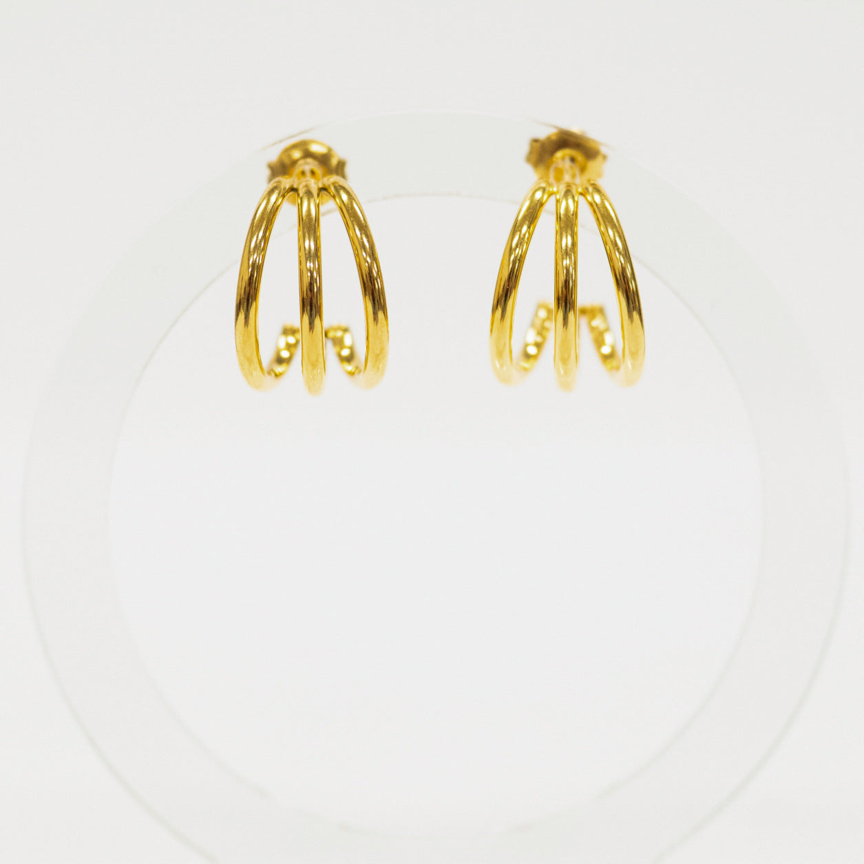 Pair of gold hoop earrings on a white background