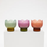 Three colorful glass cups with a white background