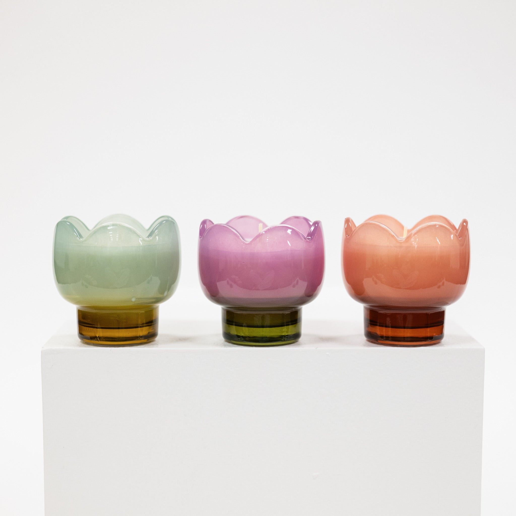 Three colorful glass cups with a white background