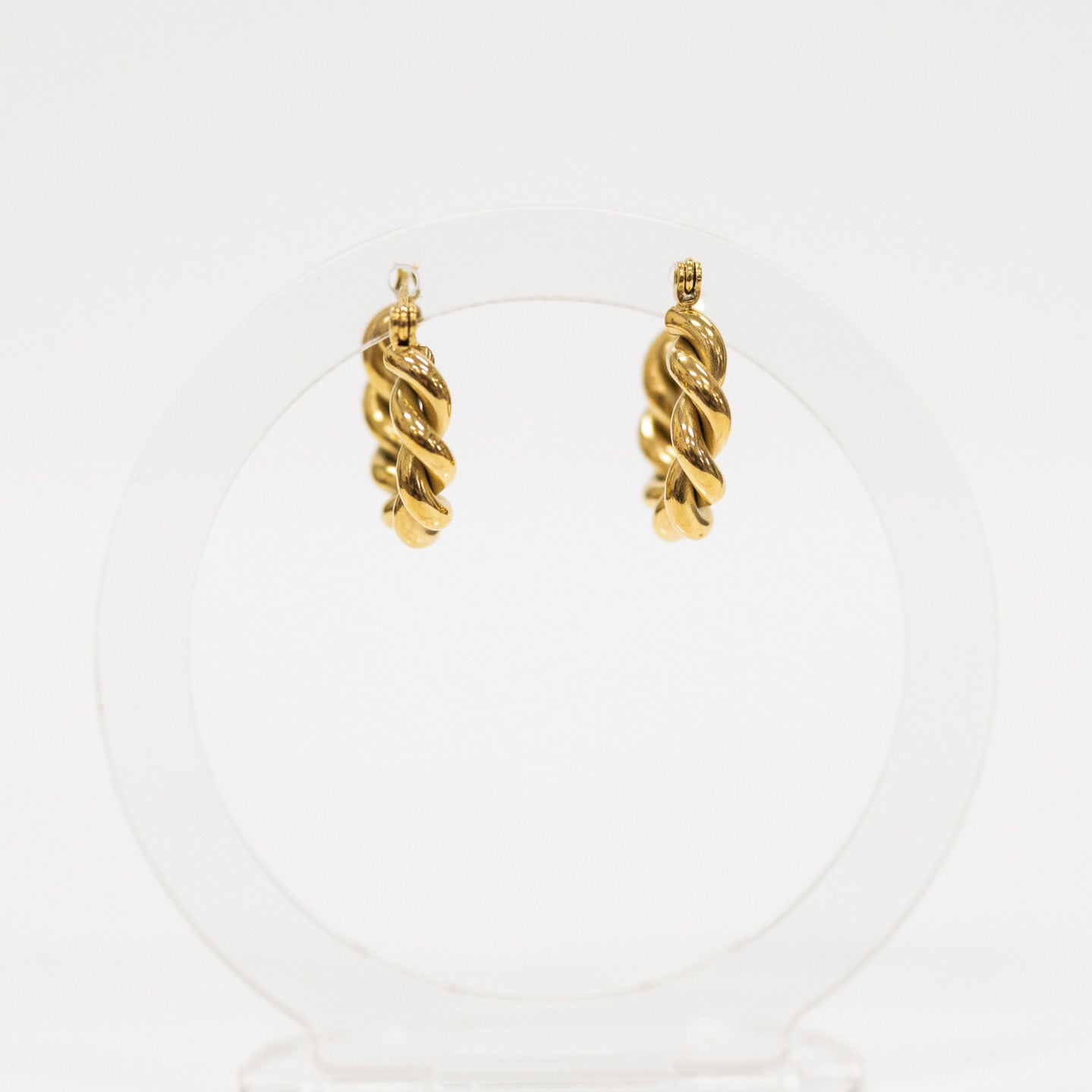 Pair of gold hoop earrings on a white background