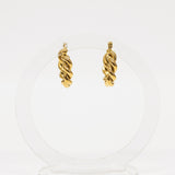 Pair of gold hoop earrings on a white background